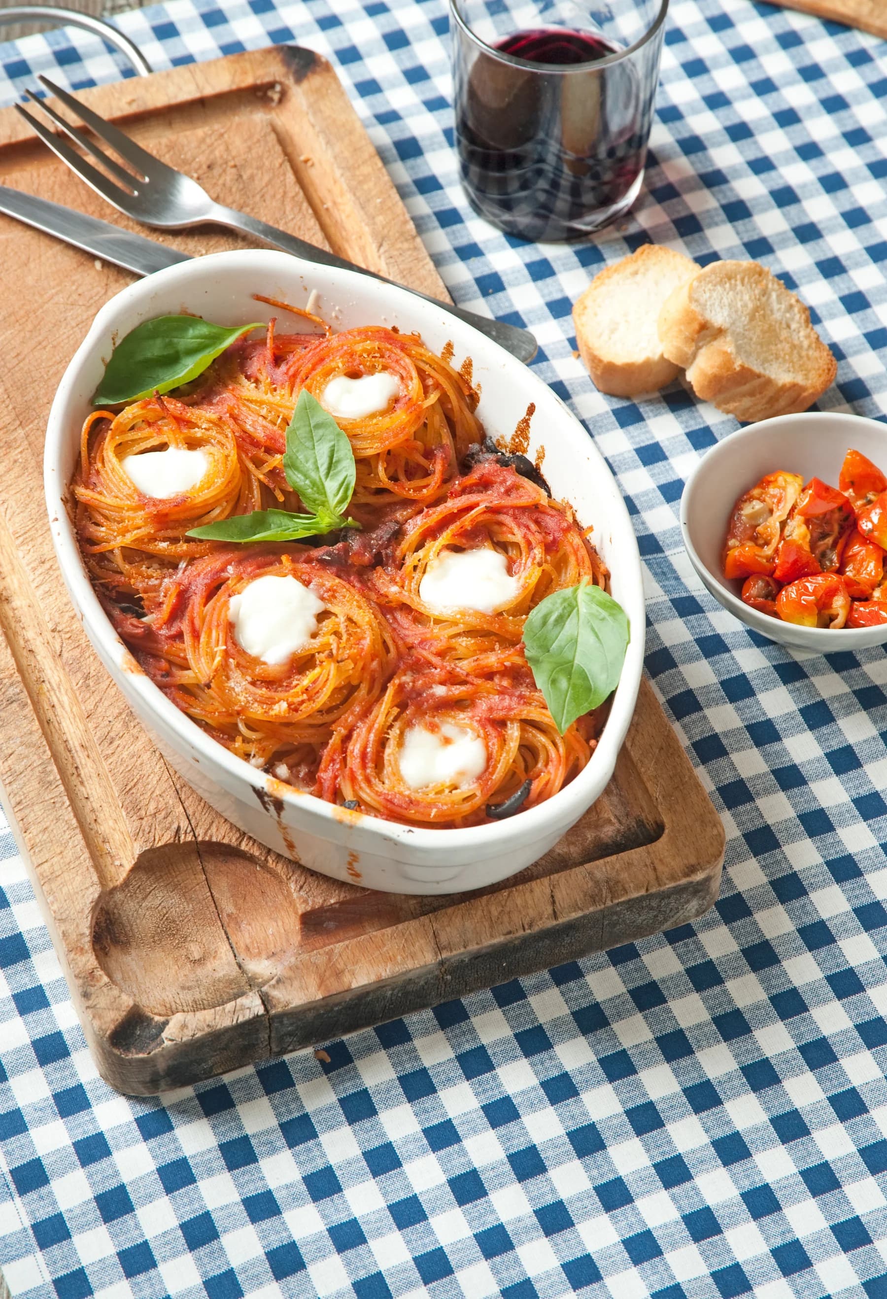 Baked pasta with tomato sauce, melted cheese and basil
