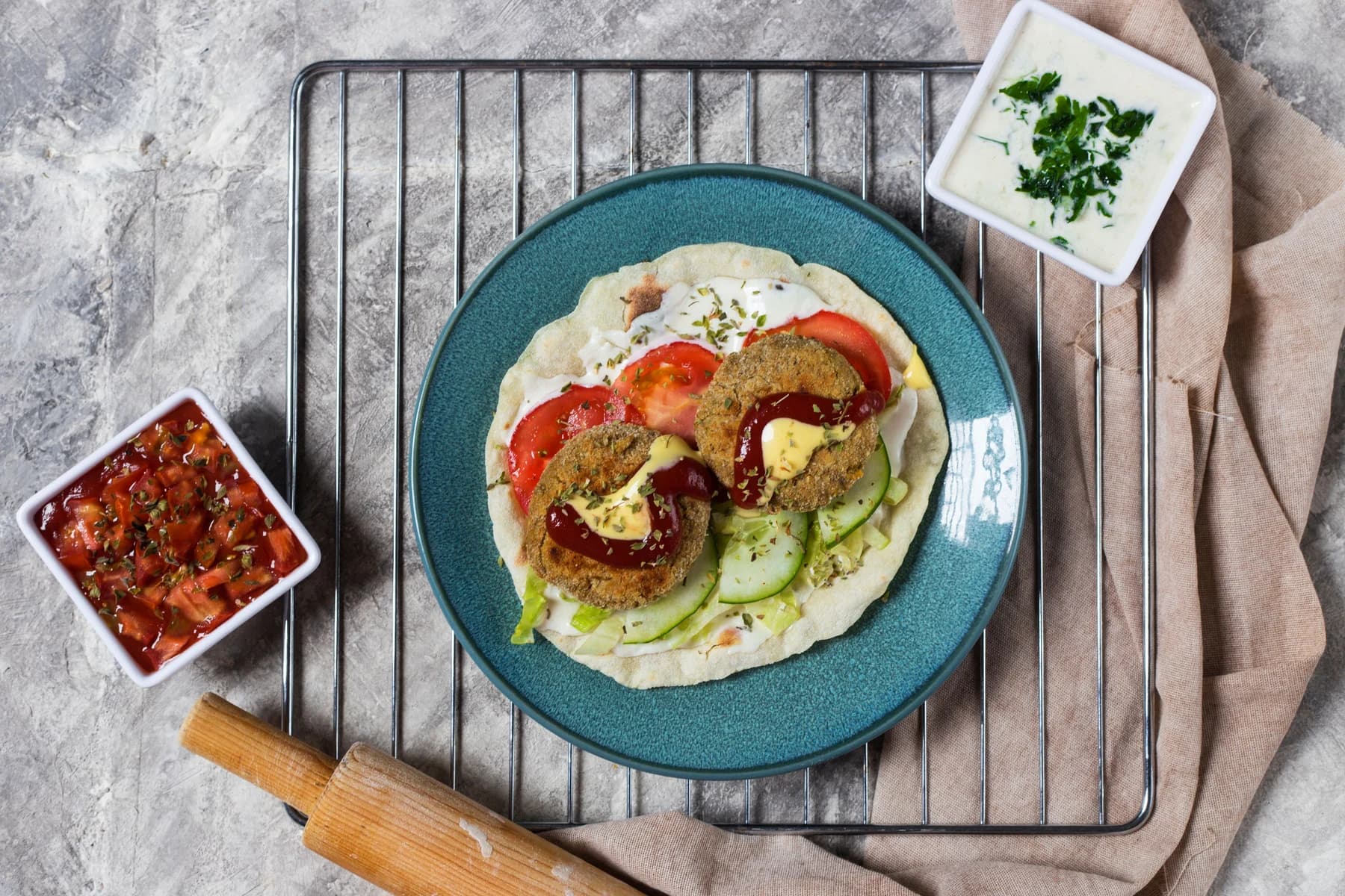 Vegetable patties with cucumber and tomatoes on flatbread